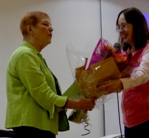 Kay Phillips receives a bouquet of flowers from guild president Anne McLauchlan